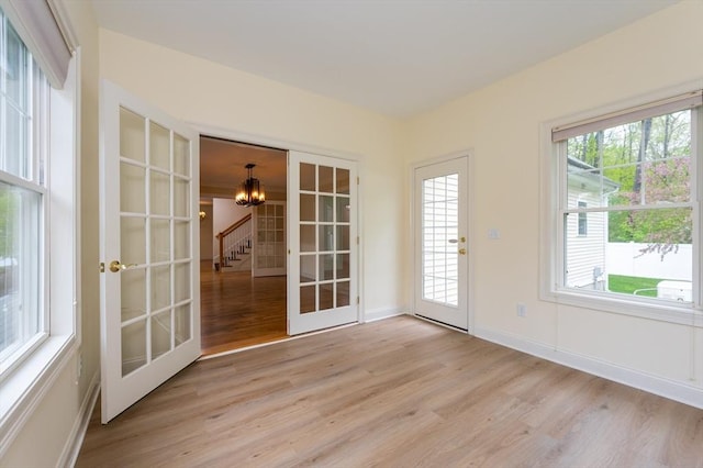14 Chandler Ln, Amherst, NH 03031 - unfurnished sunroom featuring a chandelier, healthy amount of natural light, and french doors