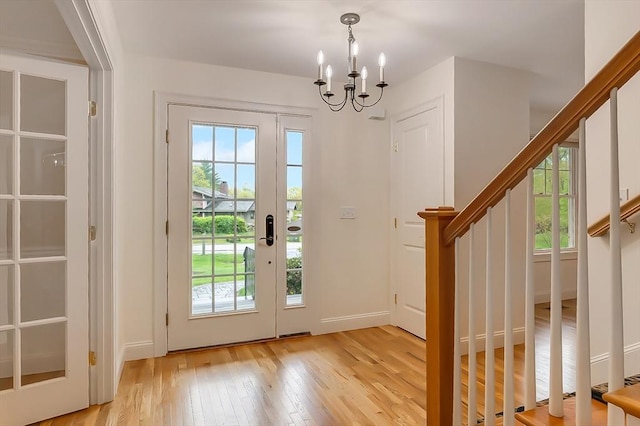 14 Chandler Ln, Amherst, NH 03031 - entryway with stairway, light wood-style flooring, and a chandelier
