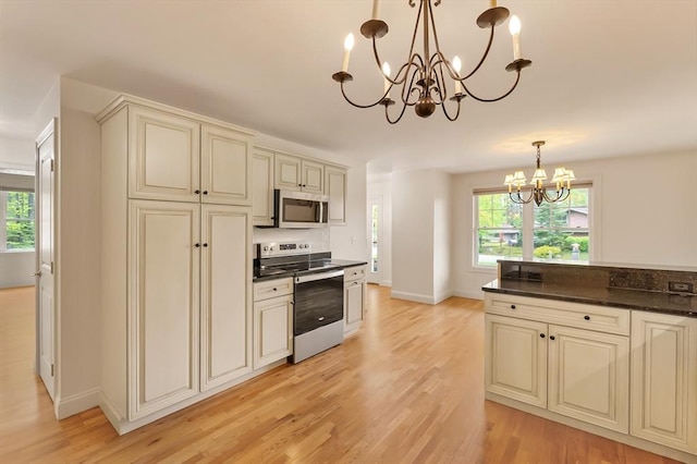 14 Chandler Ln, Amherst, NH 03031 - kitchen featuring stainless steel appliances, cream cabinetry, a chandelier, light wood-style floors, and hanging light fixtures