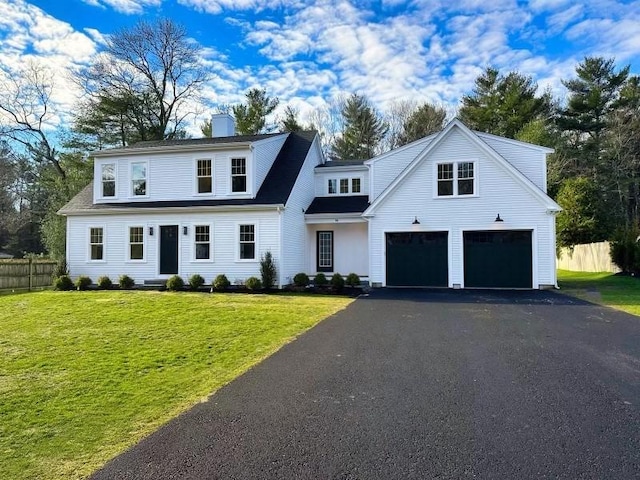 view of front of home with a garage and a front yard