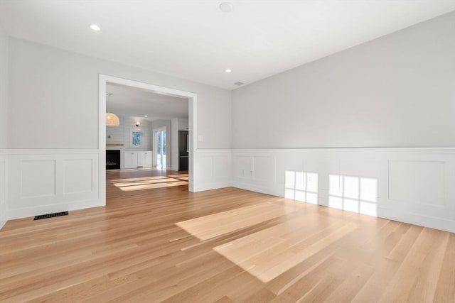 interior space featuring hardwood / wood-style floors and a large fireplace