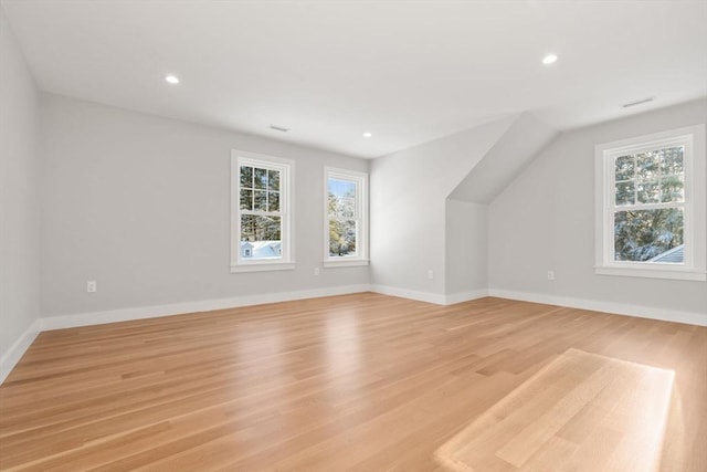 additional living space featuring light hardwood / wood-style flooring and lofted ceiling