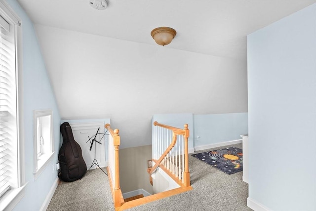 stairs featuring carpet floors, plenty of natural light, and baseboards