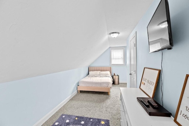 bedroom with carpet flooring, lofted ceiling, and baseboards