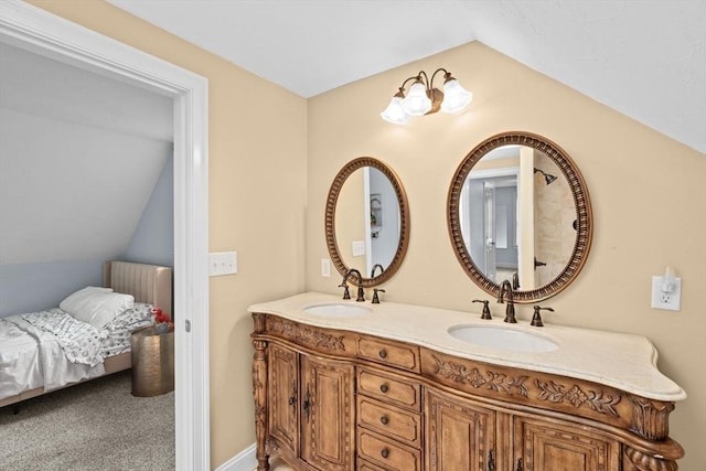 ensuite bathroom featuring vaulted ceiling and double vanity