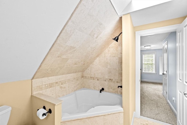 full bath with toilet and baseboards