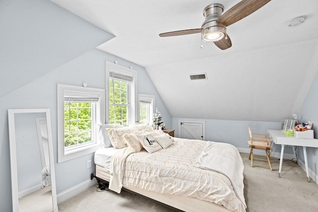carpeted bedroom featuring vaulted ceiling, baseboards, and a ceiling fan