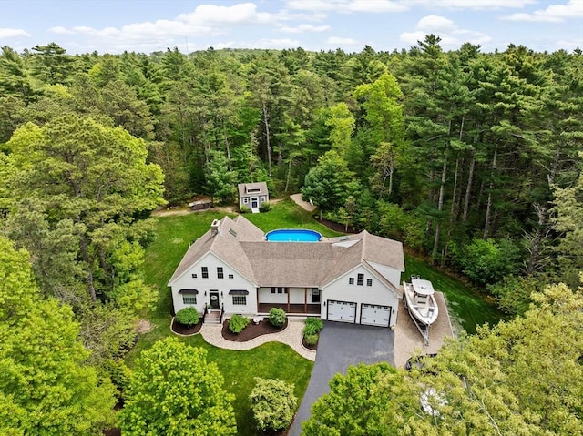 aerial view of property and surrounding area featuring a forest