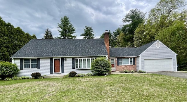 view of front of home with driveway, a garage, a chimney, and a front lawn