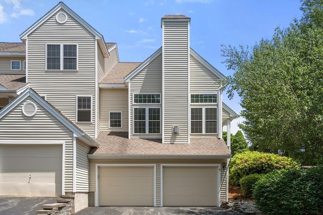 41 Edward Dr Unit 41, Grafton, MA 01536 - view of front of house with a shingled roof, driveway, a garage, and a chimney