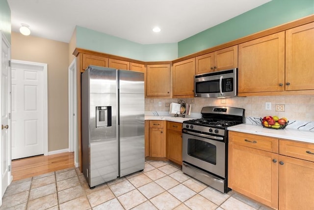41 Edward Dr Unit 41, Grafton, MA 01536 - kitchen with stainless steel appliances, light countertops, backsplash, and brown cabinetry