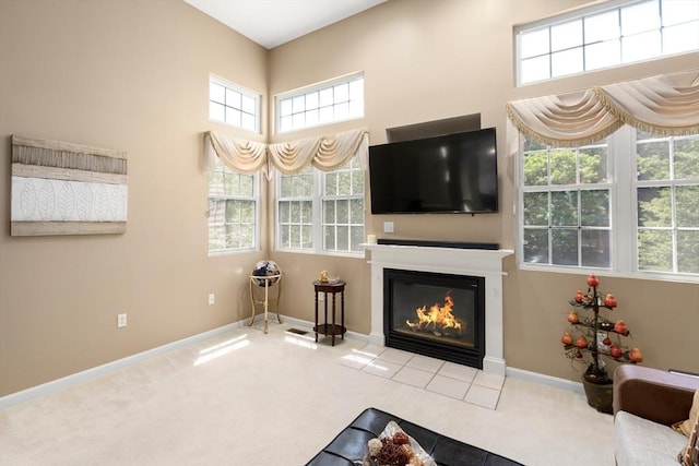41 Edward Dr Unit 41, Grafton, MA 01536 - carpeted living area featuring a glass covered fireplace, healthy amount of natural light, and a towering ceiling