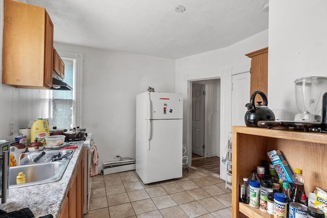 376 Elm St, Fitchburg, MA 01420 - kitchen featuring white appliances, baseboard heating, light countertops, and brown cabinetry