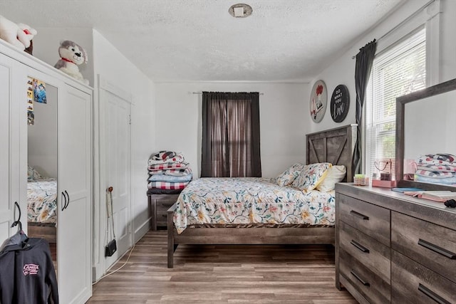 376 Elm St, Fitchburg, MA 01420 - bedroom featuring a textured ceiling and wood finished floors