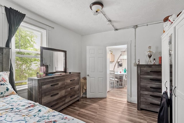 376 Elm St, Fitchburg, MA 01420 - bedroom featuring a textured ceiling and wood finished floors