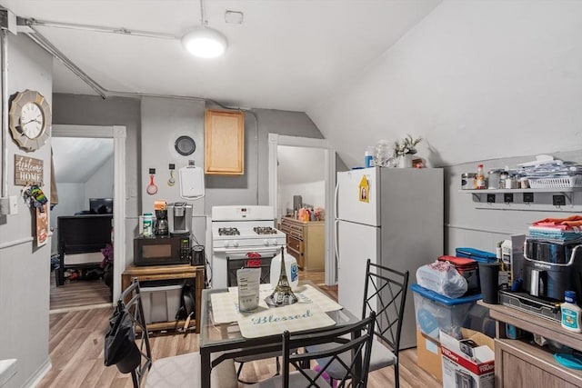 376 Elm St, Fitchburg, MA 01420 - kitchen featuring white appliances, light wood-type flooring, light brown cabinets, and vaulted ceiling