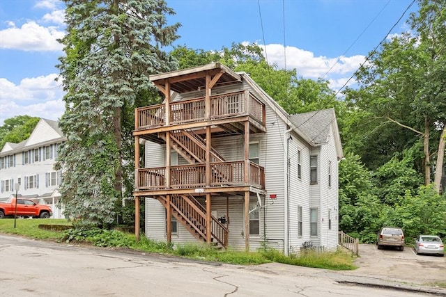 376 Elm St, Fitchburg, MA 01420 - back of house with stairway, a deck, and a shingled roof