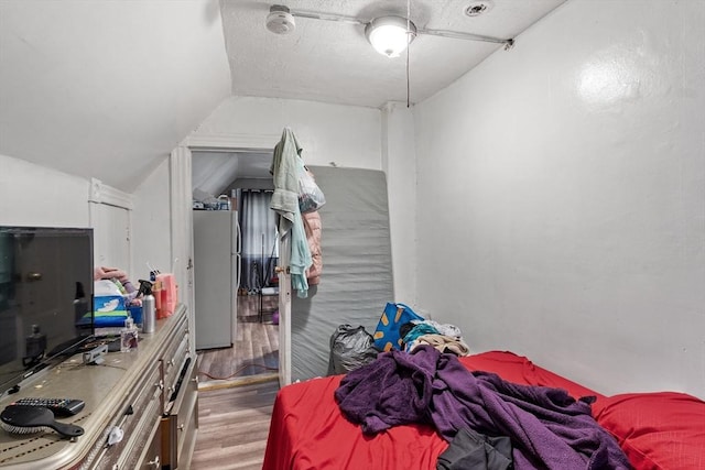 376 Elm St, Fitchburg, MA 01420 - bedroom with freestanding refrigerator, wood finished floors, lofted ceiling, and a ceiling fan