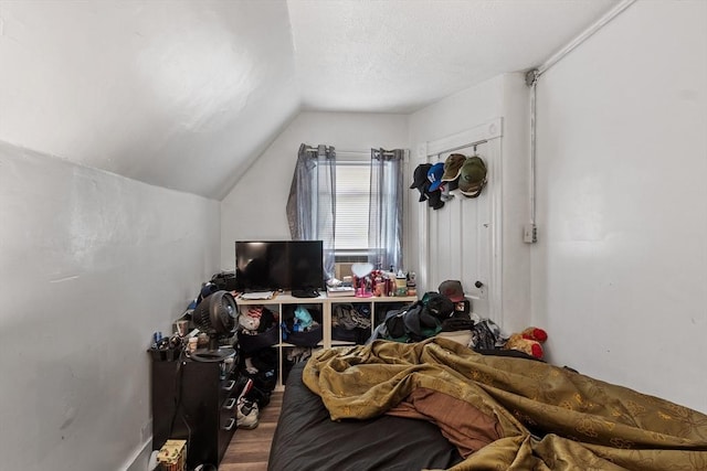 376 Elm St, Fitchburg, MA 01420 - bedroom featuring lofted ceiling, wood finished floors, and a textured ceiling