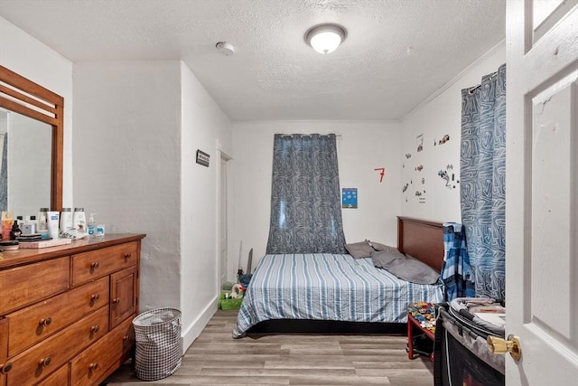 376 Elm St, Fitchburg, MA 01420 - bedroom with light wood finished floors and a textured ceiling