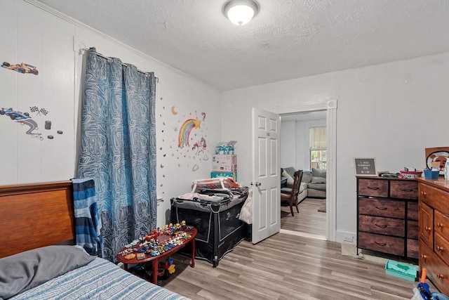 376 Elm St, Fitchburg, MA 01420 - bedroom with light wood-style flooring and a textured ceiling