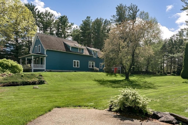 rear view of property with a lawn