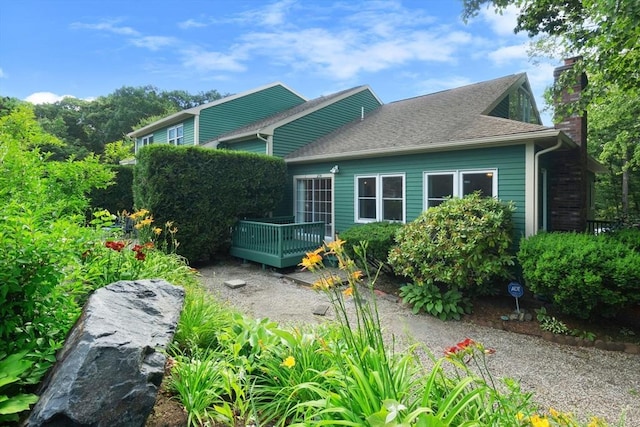 back of property with a wooden deck