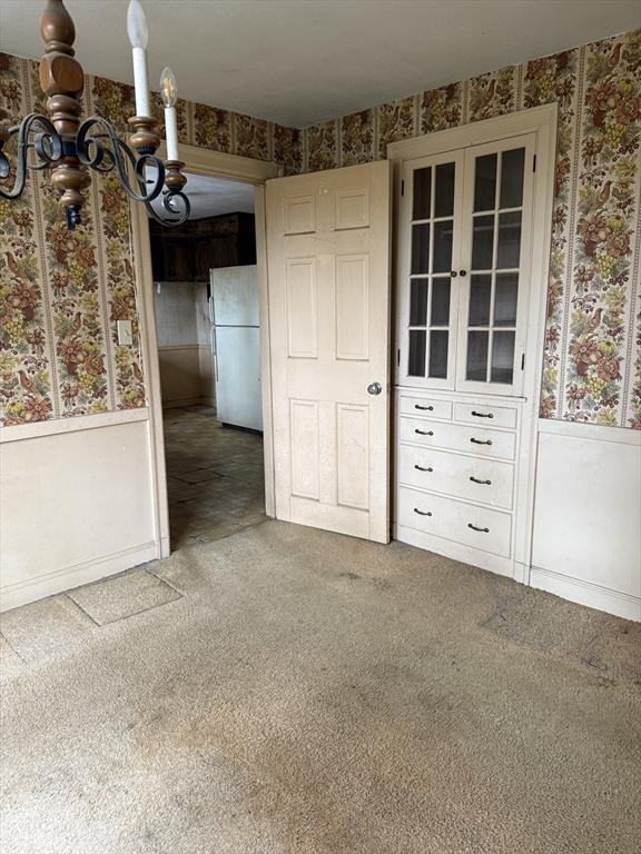 interior space featuring carpet flooring and white refrigerator