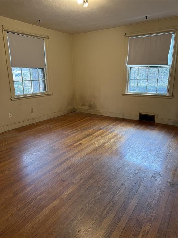 unfurnished room featuring hardwood / wood-style floors