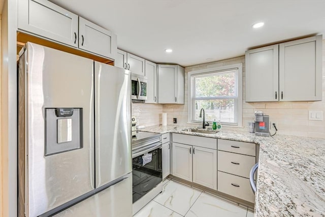 44 Georgetown St, Springfield, MA 01104 - kitchen with stainless steel appliances, light marble finish floors, light stone countertops, backsplash, and recessed lighting