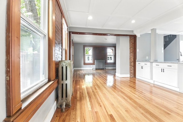 17 Manhattan St, Springfield, MA 01109 - unfurnished living room featuring radiator, light wood-type flooring, baseboards, and recessed lighting