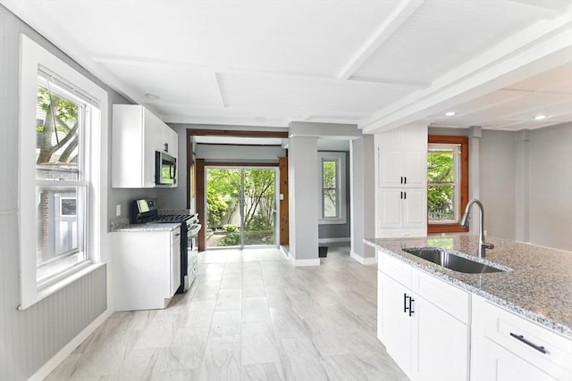 17 Manhattan St, Springfield, MA 01109 - kitchen with appliances with stainless steel finishes, a sink, light stone countertops, white cabinets, and recessed lighting