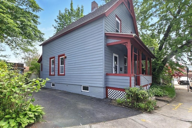 17 Manhattan St, Springfield, MA 01109 - view of property exterior with a chimney, a shingled roof, and covered porch