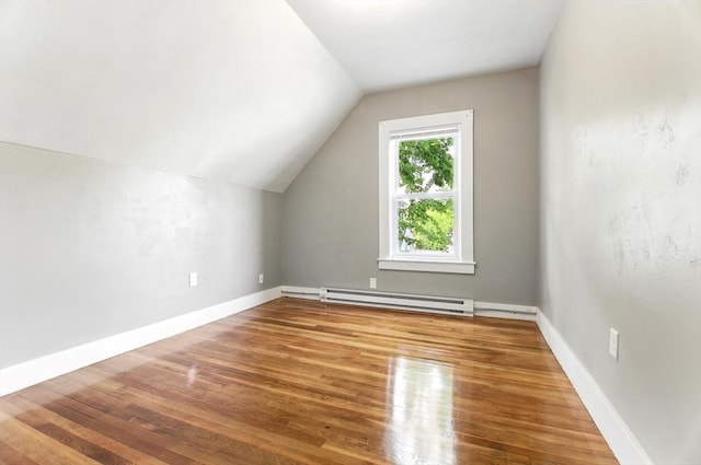 17 Manhattan St, Springfield, MA 01109 - additional living space with a baseboard heating unit, wood finished floors, vaulted ceiling, and baseboards