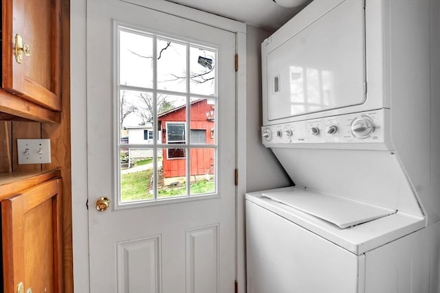 laundry area with stacked washer and clothes dryer