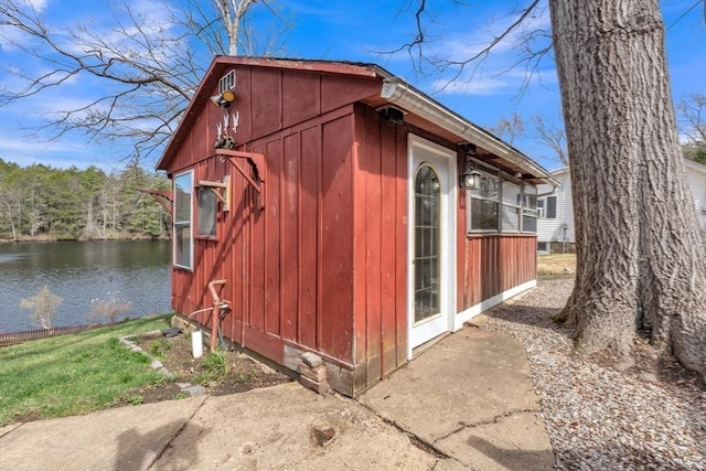 view of outbuilding featuring a water view and an outbuilding