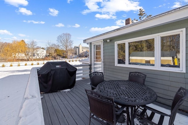 snow covered deck featuring area for grilling