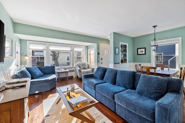 living room with radiator and dark hardwood / wood-style flooring