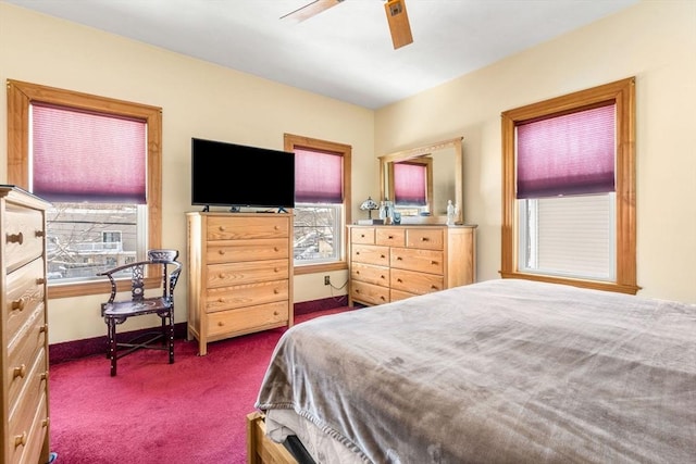 bedroom with a ceiling fan, carpet flooring, and baseboards