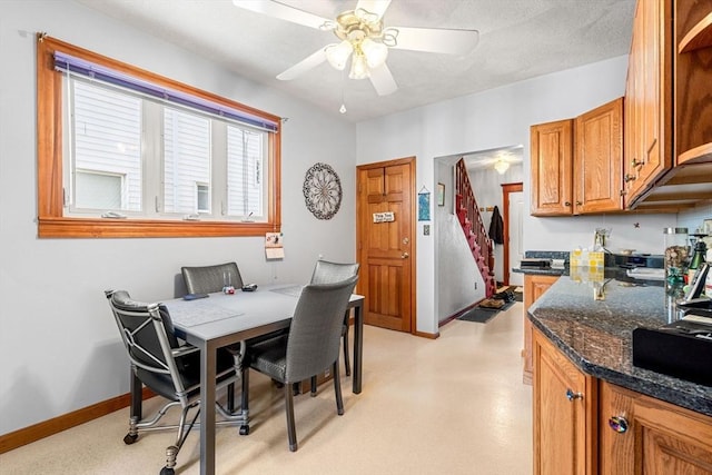 dining room featuring ceiling fan and baseboards