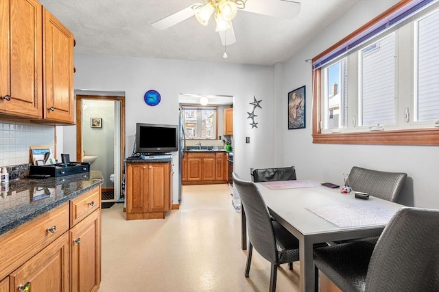 dining room featuring ceiling fan, light floors, and a wealth of natural light