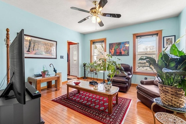 living area with light wood finished floors and ceiling fan