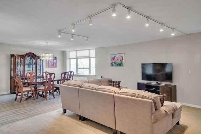 living room featuring light hardwood / wood-style floors and a chandelier