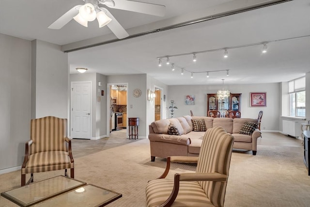 carpeted living room with ceiling fan with notable chandelier and radiator heating unit