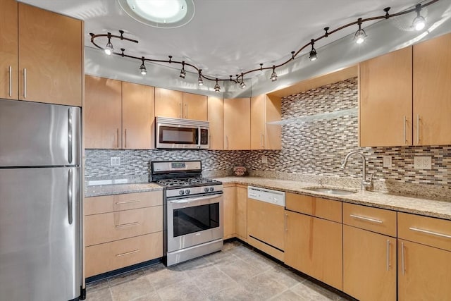 kitchen with tasteful backsplash, sink, stainless steel appliances, and light brown cabinetry