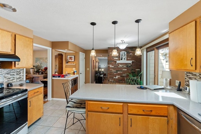 1 Redgate Ln, Holden, MA 01520 - kitchen with stainless steel appliances, a peninsula, tasteful backsplash, light countertops, and light tile patterned floors