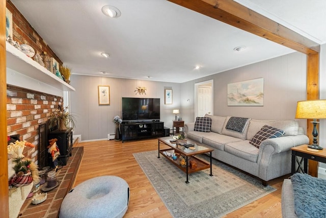 1 Redgate Ln, Holden, MA 01520 - living room featuring wood finished floors, a brick fireplace, recessed lighting, a baseboard radiator, and wood walls