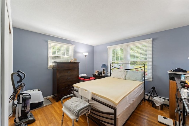 1 Redgate Ln, Holden, MA 01520 - bedroom featuring wood finished floors, a baseboard heating unit, and an office area