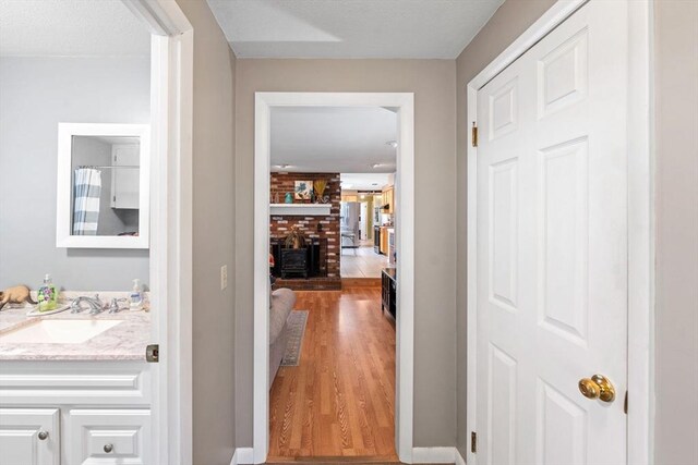 1 Redgate Ln, Holden, MA 01520 - corridor with wood finished floors and a sink