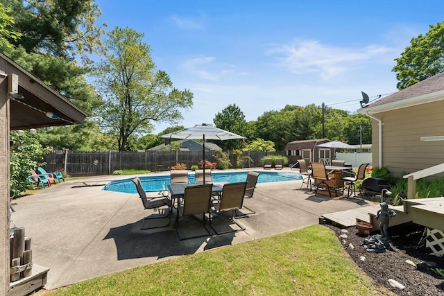 1 Redgate Ln, Holden, MA 01520 - view of pool featuring a storage unit, a fenced backyard, outdoor dining space, and a patio